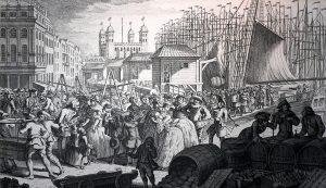 In 1757 the artist Louis Philippe Boitard produced a view of the Legal Quays, between Billingsgate Dock and the Tower of London.[1] Boitard's engraving, 'Imports from France', provided a satirical look at Londoners' passion for French luxury goods and manners. Although Boitard deliberately exaggerated the number of both people and shipping, he also provided the most accurate picture of the Legal Quays at work. Boitard recorded treadwheel cranes, beamscales, Customs' Officers gauging barrels and porters handling cargoes. Smuggling, theft and pilferage of cargoes were rife on both the busy open wharves and in the crowded warehouses. https://en.wikipedia.org/wiki/File:Imports_from_France_Boitard_1757.jpg [Public Domain]